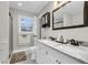 Modern bathroom with marble countertop, double vanity and black framed mirror at 127 Roberts Rd, Summerville, SC 29483