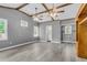 Expansive living area with high ceilings, two fans, hardwood floors, and abundant natural light from large windows at 127 Roberts Rd, Summerville, SC 29483