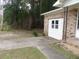 Side view of home with driveway, brick facade, and garage with a window at 1277 Russellville Rd, Saint Stephen, SC 29479