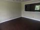 Bright living room featuring hardwood floors and large windows, creating a welcoming atmosphere at 1277 Russellville Rd, Saint Stephen, SC 29479