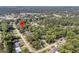 A wide aerial view captures a residential neighborhood, showcasing its layout and surrounding greenery at 1391 Fairfield Ave, Charleston, SC 29407