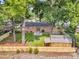 Aerial view of the backyard featuring patio seating, shed, grassy area, and mature trees at 1391 Fairfield Ave, Charleston, SC 29407