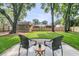A backyard patio with seating area looks out to a large yard, shed, and privacy fence at 1391 Fairfield Ave, Charleston, SC 29407