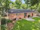 Aerial shot shows a brick home's backyard with green lawn, patio, shed, and mature trees at 1391 Fairfield Ave, Charleston, SC 29407