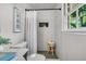 Bright bathroom featuring a shower, a framed art piece, and natural light from the window at 1391 Fairfield Ave, Charleston, SC 29407