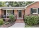 Close-up of home's entrance, highlighting the landscaped pathway and brick steps at 1391 Fairfield Ave, Charleston, SC 29407