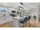 Kitchen featuring white cabinets, stainless appliances, island with seating, and modern lighting at 1391 Fairfield Ave, Charleston, SC 29407