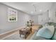 Cozy living room with hardwood floors, window views, and comfortable seating, creating an inviting atmosphere at 1391 Fairfield Ave, Charleston, SC 29407