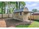 Well-maintained wooden shed in a backyard featuring a lattice base and covered side porch at 1391 Fairfield Ave, Charleston, SC 29407