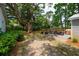 Large backyard with mature tree, patio furniture, and partial fence at 1408 Goblet Ave, Mount Pleasant, SC 29464