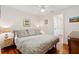 Bedroom features a large bed, hardwood floors, wainscotting, and neutral decor at 1408 Goblet Ave, Mount Pleasant, SC 29464