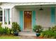 Charming front door with teal shutters, a cheerful wreath, and potted flowers at 1408 Goblet Ave, Mount Pleasant, SC 29464