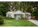 Charming home featuring turquoise shutters, a landscaped yard, and a welcoming front porch at 1408 Goblet Ave, Mount Pleasant, SC 29464