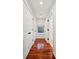 Hallway features hardwood floors, closet doors, and natural light through a window at 1408 Goblet Ave, Mount Pleasant, SC 29464