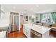 Kitchen features a stainless steel fridge, white cabinets, and an island with a farmhouse sink at 1408 Goblet Ave, Mount Pleasant, SC 29464