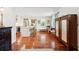 Open-concept space featuring wood floors, white trim, and a view into the modern kitchen at 1408 Goblet Ave, Mount Pleasant, SC 29464
