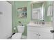 A relaxing bathroom with a white vanity, toilet and shower/tub combination at 1494 N Lakeshore Dr, Mount Pleasant, SC 29466