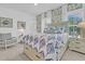 A bright bedroom features a decorative wallpaper, a queen bed, and modern decor at 1494 N Lakeshore Dr, Mount Pleasant, SC 29466