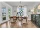 A dining room features a wood table set for four, chandelier, and access to the outdoor area at 1494 N Lakeshore Dr, Mount Pleasant, SC 29466