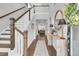 Welcoming foyer with a staircase and hardwood floors, leading into an open living space at 1494 N Lakeshore Dr, Mount Pleasant, SC 29466