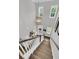 View from the top of staircase looking into the foyer with natural light at 1494 N Lakeshore Dr, Mount Pleasant, SC 29466