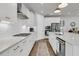 Bright kitchen featuring white cabinets, stainless steel appliances, and a spacious countertop at 1494 N Lakeshore Dr, Mount Pleasant, SC 29466