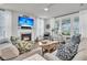 Cozy living room with fireplace, plush seating, and ample natural light streaming through large windows at 1494 N Lakeshore Dr, Mount Pleasant, SC 29466