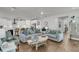 Open-concept living area showcasing hardwood floors, plush sofas, and seamless flow to the kitchen at 1494 N Lakeshore Dr, Mount Pleasant, SC 29466