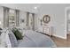 A bright bedroom features soft decor, a king bed with patterned bedding, and a cushioned bench at 1494 N Lakeshore Dr, Mount Pleasant, SC 29466
