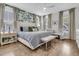 A luxurious bedroom is bright and airy, featuring a king bed and multiple windows at 1494 N Lakeshore Dr, Mount Pleasant, SC 29466