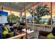 Relaxing outdoor screened porch features a porch swing, ceiling fan, and outdoor furniture with a TV in the background at 1494 N Lakeshore Dr, Mount Pleasant, SC 29466