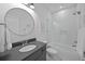 Modern bathroom showcasing a sleek vanity, round mirror, subway tile shower, and glass door for a clean aesthetic at 1557 Kepley Dr, Mount Pleasant, SC 29464
