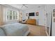 Comfortable bedroom with window, a chair, flat screen TV, and natural light at 1557 Kepley Dr, Mount Pleasant, SC 29464