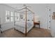 Bright bedroom featuring a four poster bed, bedside tables, hardwood floors, and a neutral color palette at 1557 Kepley Dr, Mount Pleasant, SC 29464