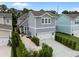 Charming two-story home with a manicured lawn, two car garage, and beautiful landscaping at 1557 Kepley Dr, Mount Pleasant, SC 29464