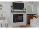A cozy living room fireplace with mantel, shiplap accent, and mounted TV at 1557 Kepley Dr, Mount Pleasant, SC 29464