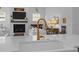 A kitchen island features a white farm sink with gold faucet; open-concept living area at 1557 Kepley Dr, Mount Pleasant, SC 29464