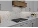 This modern kitchen features a gas cooktop, elegant backsplash, and light gray cabinetry at 1557 Kepley Dr, Mount Pleasant, SC 29464