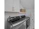 Laundry room featuring front load washer and dryer, overhead cabinets, gold hardware and a neutral color palette at 1557 Kepley Dr, Mount Pleasant, SC 29464
