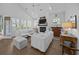 Well-lit living room boasts a fireplace, plush white sofas, and a ceiling fan at 1557 Kepley Dr, Mount Pleasant, SC 29464
