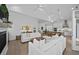 Bright, open living area with a fireplace, sofas, and a view into the kitchen at 1557 Kepley Dr, Mount Pleasant, SC 29464