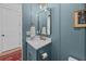 The powder room showcases a vanity with gold fixtures, bright light, and stylish design at 1557 Kepley Dr, Mount Pleasant, SC 29464
