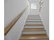 Stairway featuring hardwood treads, white risers and stringers, a wood handrail and a neutral color palette at 1557 Kepley Dr, Mount Pleasant, SC 29464