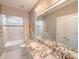 Well-lit bathroom boasting granite countertop, large mirror, and tiled shower/tub at 157 Village Ponds Dr, Summerville, SC 29483