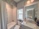 Charming bathroom featuring a bathtub, window, designer mirror and granite-topped vanity at 157 Village Ponds Dr, Summerville, SC 29483