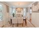 Inviting dining space with large windows and contemporary chandelier at 157 Village Ponds Dr, Summerville, SC 29483