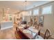 Dining room with decorative chandelier, window trim detail, and seating for five people at 157 Village Ponds Dr, Summerville, SC 29483