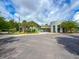 Community center exterior with American flag, palm trees, and ample parking at 157 Village Ponds Dr, Summerville, SC 29483