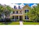 Inviting two-story home with a welcoming front porch, beautiful landscaping, and a well-kept lawn at 157 Village Ponds Dr, Summerville, SC 29483