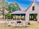 Outdoor seating area with fire pit, picnic tables, and covered building entrance at 157 Village Ponds Dr, Summerville, SC 29483